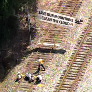 Protestors chain themselves to tracks to block coal train near Duke Energy plant