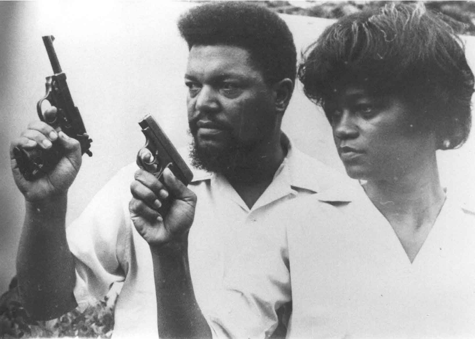 Robert and Mabel Williams holding pistols. Photo via Freedom Archives.